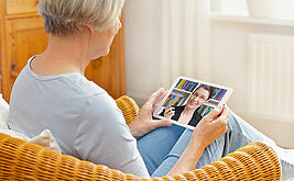 Ältere Dame führt Videogespräch auf Tablet