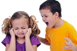 streitende Kinder: Junge brüllt, Mädchen hält sich die Ohren zu